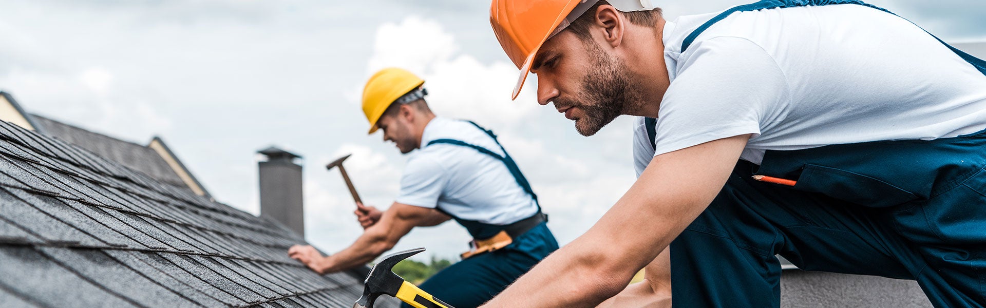 two workers working on roof